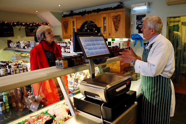 Britain's Prime Minister Theresa May speaks with Jerry Rook visits a local butchers shop in her constituency of Maidenhead ahead of Small Business Saturday, in Maidenhead, Britain December 2, 2016. REUTERS/Stefan Wermuth - RTSUC7X